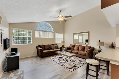 a living room with a couch and a table at Gorgeous Place Minutes Away from Attractions in Kissimmee