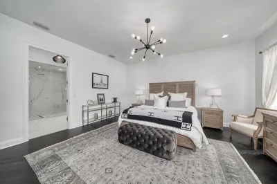 a bedroom with a large bed and a bathroom at Celebration FL 34747 in Orlando