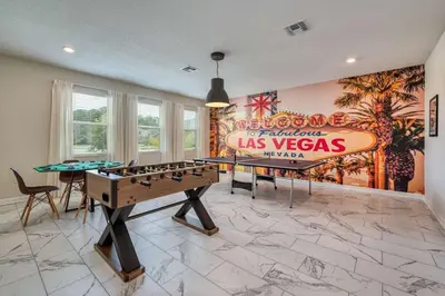 a room with a pool table and a sign on the wall at Chic Luxury Decor Prime Location Game Room Bliss in Kissimmee