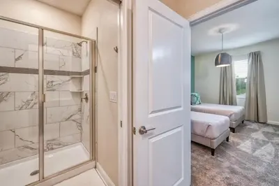 a bathroom with a walk in shower and a tub at Chic Luxury Decor Prime Location Game Room Bliss in Kissimmee