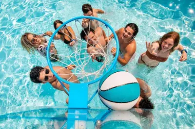 a group of people playing volley ball in a pool at DisneyResortVillas by AmericanVacationLiving 1 BR in Orlando