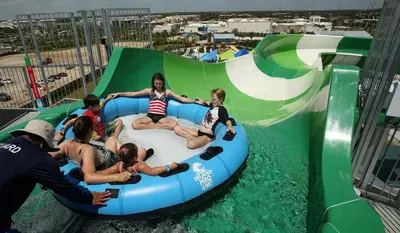 a group of people riding a ride in an inflatable at DisneyResortVillas by AmericanVacationLiving 1 BR in Orlando