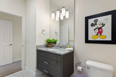 a bathroom with a sink and a mirror at Priceless Peace at Serenity by Shine Villas, 081 townhouse in Orlando