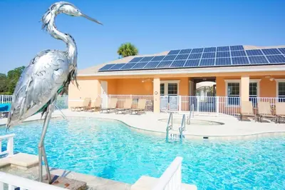 a statue of a bird in the water in a pool at Priceless Peace at Serenity by Shine Villas, 081 townhouse in Orlando