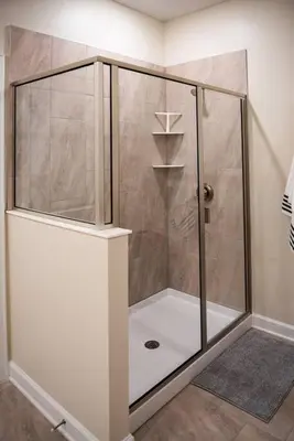 a shower with a glass enclosure in a bathroom at Luxury and Fun near DISNEY PARKS 9BR in Kissimmee