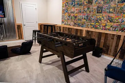 a room with a foosball table in front of a wall at Luxury and Fun near DISNEY PARKS 9BR in Kissimmee