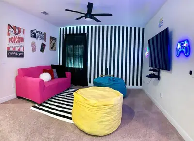 a living room with a pink couch and a yellow ottoman at Gorgeous Remo 8 BR at Encore Resort next to Disney in Orlando