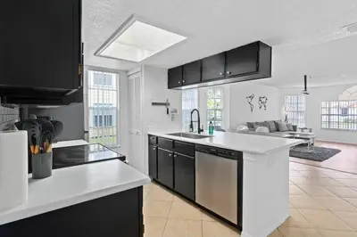 a kitchen with black cabinets and white counter tops at DONOT BOOK thakn you in Kissimmee