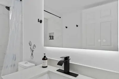 a white bathroom with a sink and a mirror at DONOT BOOK thakn you in Kissimmee