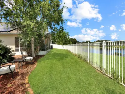a white fence with two chairs and a bench at No place like home in Oviedo