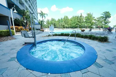 a hot tub in a courtyard next to a pool at Orlando Blue Heron Beach Resort Renewed apartment in Orlando