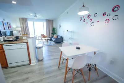 a kitchen and living room with a white table and chairs at Orlando Blue Heron Beach Resort Renewed apartment in Orlando