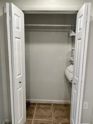 a closet with a door open with a towel at Beautiful Bungalow in Orlando