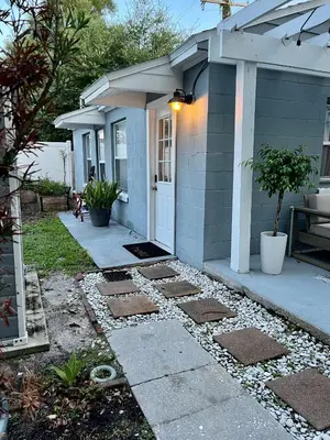 a house with a pathway leading to the front door at Beautiful Bungalow in Orlando