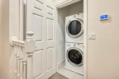 a laundry room with a washer and dryer next to a door at Distinctive Home Private Pool in Orlando