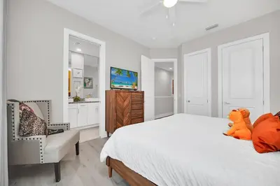 a bedroom with a bed with a teddy bear sitting on it at Magical Residence Resort, 5 min Disney in Orlando
