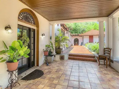 a porch of a house with potted plants at 4,800 sf Estate Pool Lake Weddings and Events in Orlando