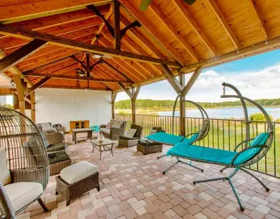 an outdoor patio with chairs and chairs and a table at 4,800 sf Estate Pool Lake Weddings and Events in Orlando