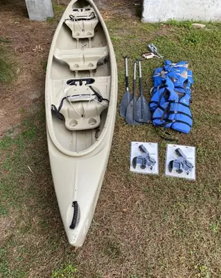 a white kayak sitting on the grass next to tools at 4,800 sf Estate Pool Lake Weddings and Events in Orlando