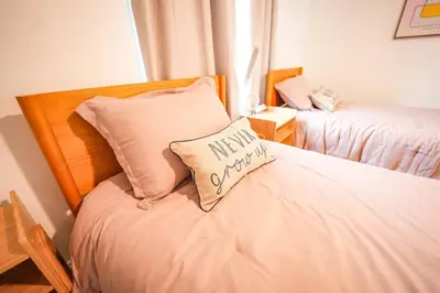 a bedroom with a bed with a pillow with a mum overheard at ORLANDO - BLUE HERON Great Apt - 7 pax in Orlando