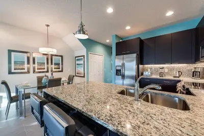 a kitchen with a sink and a counter top at Super cozy home with private pool in Orlando