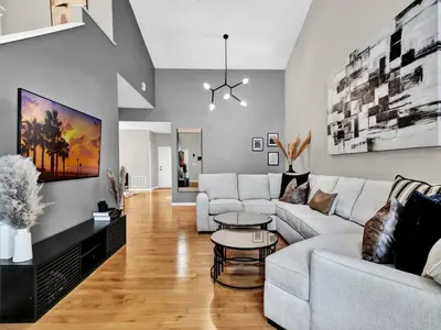 a living room with a white couch and a table at Beautiful townhouse centrally located in Orlando