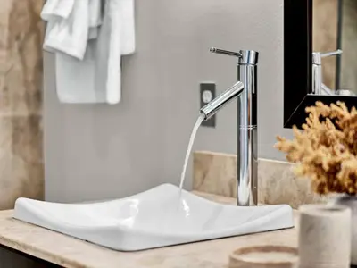 a white sink in a bathroom with a faucet at Beautiful townhouse centrally located in Orlando