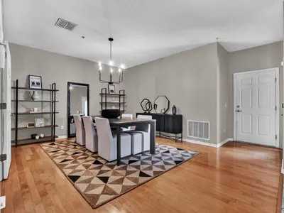 a living room with a checkered floor and a table and chairs at Beautiful townhouse centrally located in Orlando