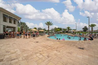 a group of people in a pool at a resort at Poolside Paradise at Storey Lake: 2-Bedroom in Kissimmee