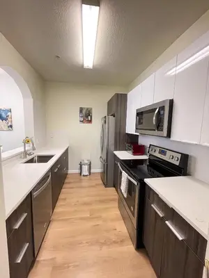 a kitchen with white counters and stainless steel appliances at Windsor Palms, next to clubhouse in Kissimmee