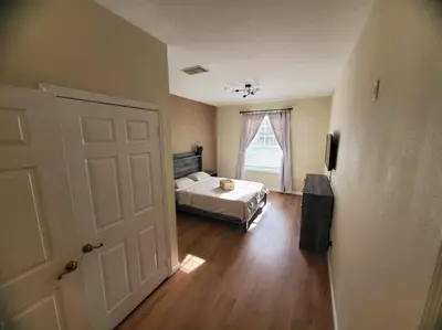 a bedroom with a bed and a window and a door at Windsor Palms, next to clubhouse in Kissimmee