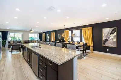 a large kitchen and living room with a large island at EPIC 10min Disney Fun Villa, Mini Golf, Arcade, Theater in Orlando