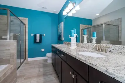 a bathroom with a sink and a blue wall at EPIC 10min Disney Fun Villa, Mini Golf, Arcade, Theater in Orlando