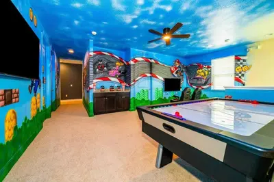 a games room with a pool table and a ceiling fan at EPIC 10min Disney Fun Villa, Mini Golf, Arcade, Theater in Orlando