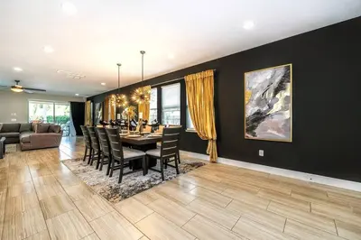 a dining room with a table and chairs at EPIC 10min Disney Fun Villa, Mini Golf, Arcade, Theater in Orlando