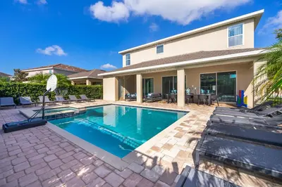 a swimming pool in the backyard of a house at EPIC Disney 10Min Retreat, 8BR Resort Villa and Arcade in Orlando