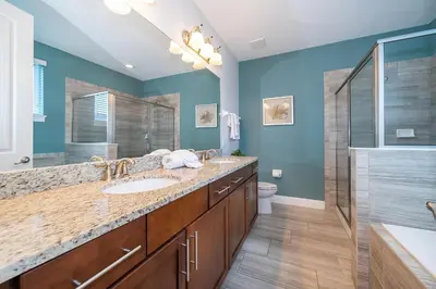 a bathroom with a sink and a shower at EPIC Disney 10Min Retreat, 8BR Resort Villa and Arcade in Orlando