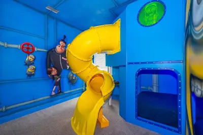 a blue play room with a yellow slide at EPIC Disney 10Min Retreat, 8BR Resort Villa and Arcade in Orlando