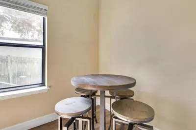 a table and two stools in a room with a window at St Cloud Vacation Rental - Walk to Lakefront Park! in Saint Cloud