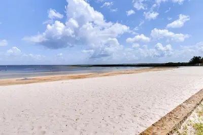 a white sandy beach with the ocean in the background at St Cloud Vacation Rental - Walk to Lakefront Park! in Saint Cloud