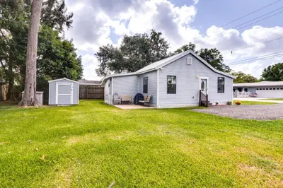 a white house with a yard at St Cloud Vacation Rental - Walk to Lakefront Park! in Saint Cloud