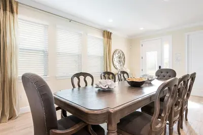 a dining room with a wooden table and chairs at 411-IBRHAIM · 411 Sparkling Spotless Villa in Encore in Orlando