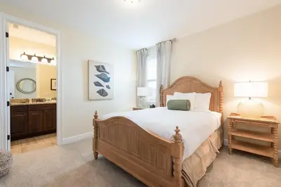 a bedroom with a large bed and a bathroom at 411-IBRHAIM · 411 Sparkling Spotless Villa in Encore in Orlando