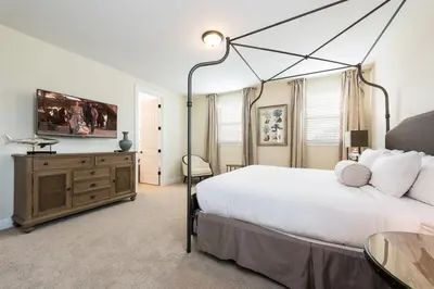 a bedroom with a large white bed and a table at 411-IBRHAIM · 411 Sparkling Spotless Villa in Encore in Orlando