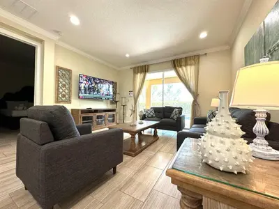 a living room with a couch and a table at 411-IBRHAIM · 411 Sparkling Spotless Villa in Encore in Orlando