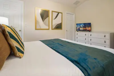 a white bedroom with a bed and a dresser at Great 6bedrooms home in Kissimmee w Private Pool 8426 in Kissimmee