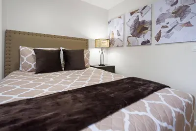 a bedroom with a large bed and a lamp at Great 6bedrooms home in Kissimmee w Private Pool 8426 in Kissimmee