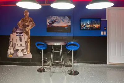 a bar with a stool and a star wars statue at Great 6bedrooms home in Kissimmee w Private Pool 8426 in Kissimmee