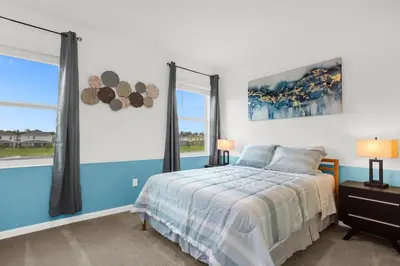 a bedroom with a bed and two windows at Super Deal - Brand New Themed 9BR Home near Disney in Kissimmee