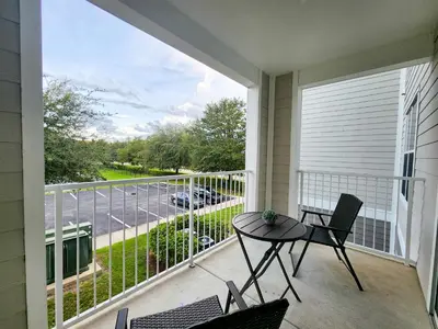 a balcony with a table and chairs and a view of a street at Retreat at Secret Lake 10 mins to Disney in Kissimmee